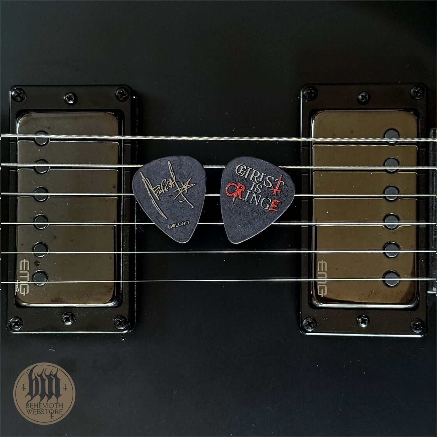 A plastic guitar pick Nergal 'Christ Is Cringe' signature