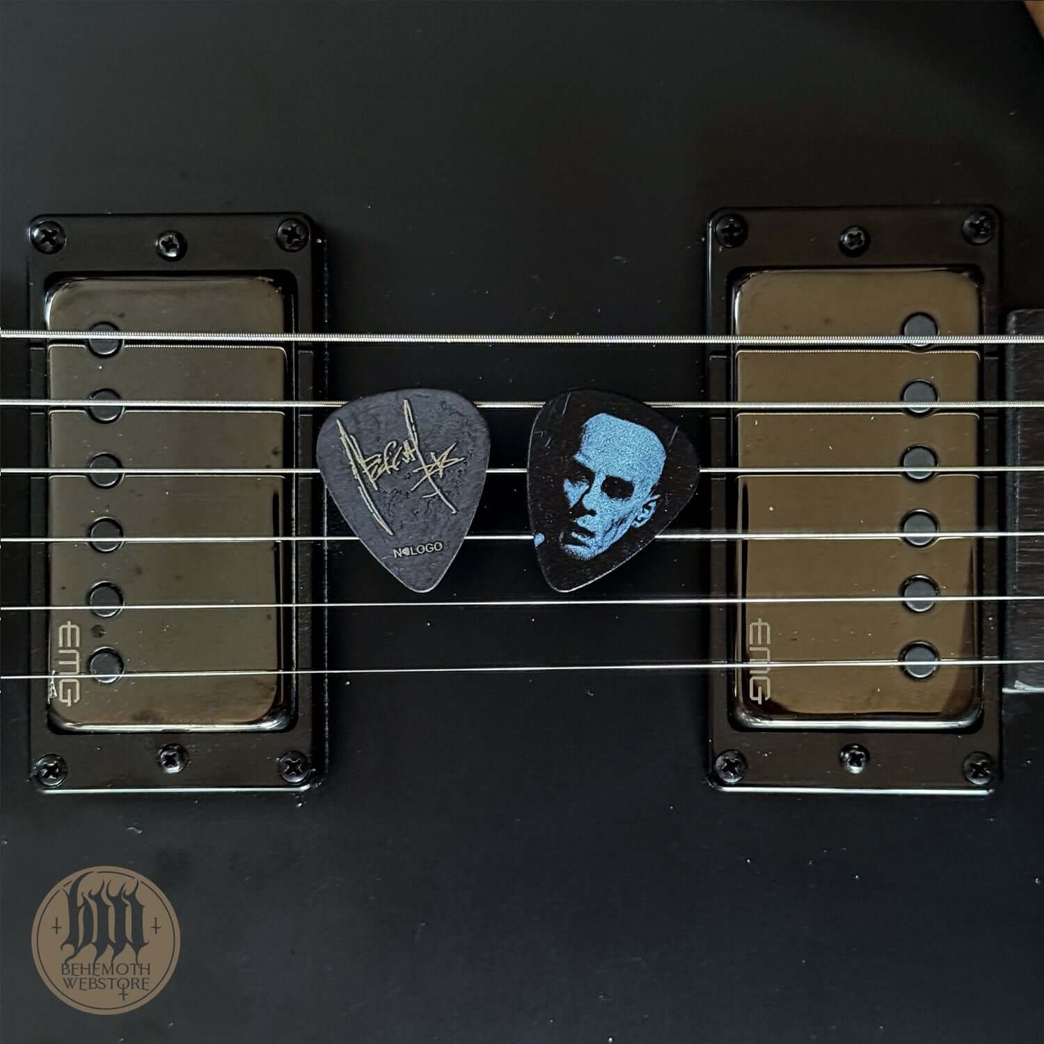 A plastic guitar pick Nergal signature 'Face'